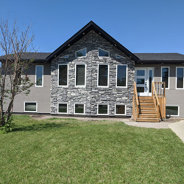 Bumblebee Stucco grey peaked house